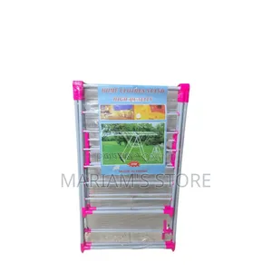 Foldable Clothes Drying Rack With a Pink and White Frame.