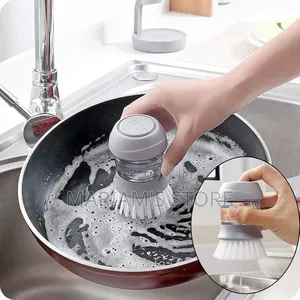 Grey Soap-dispensing Kitchen Brush For Cleaning Pots And Pans.