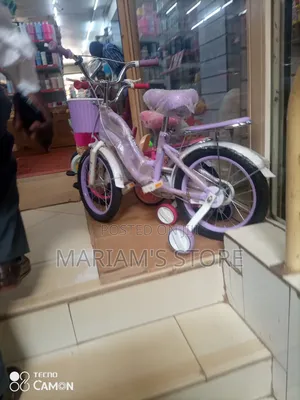 Child's Bicycle in Purple and Pink With Training Wheels .
