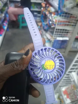 Quirk Mini Wrist Fan With a Yellow Pineapple Design.]
