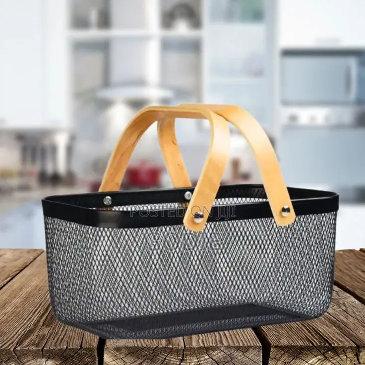 Black Metal Wire Mesh Storage Basket With Light Wood Handles.