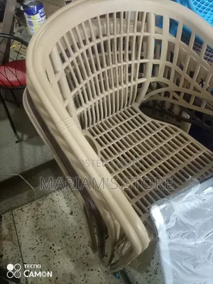 Beige Plastic Rattan-Style Patio Chair.