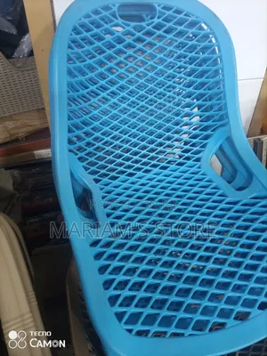 Plastic Chair With a Lattice or Web Design on the Backrest and Seat.