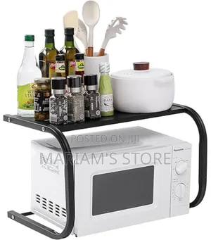 Black, Metal Kitchen Microwave Storage Rack With Adjustable Width.
