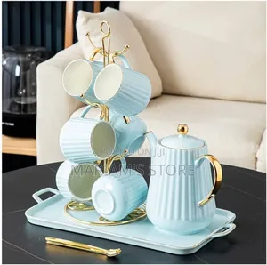 Ceramic Coffee or Tea With a Teacup and Kettle on a Rotating Tray. ]