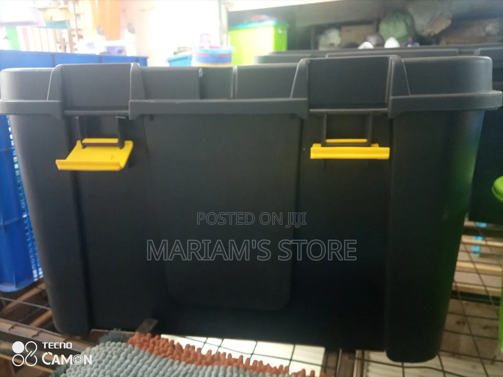 Black Heavy-Duty Plastic Storage Box With Yellow Locking Clips.