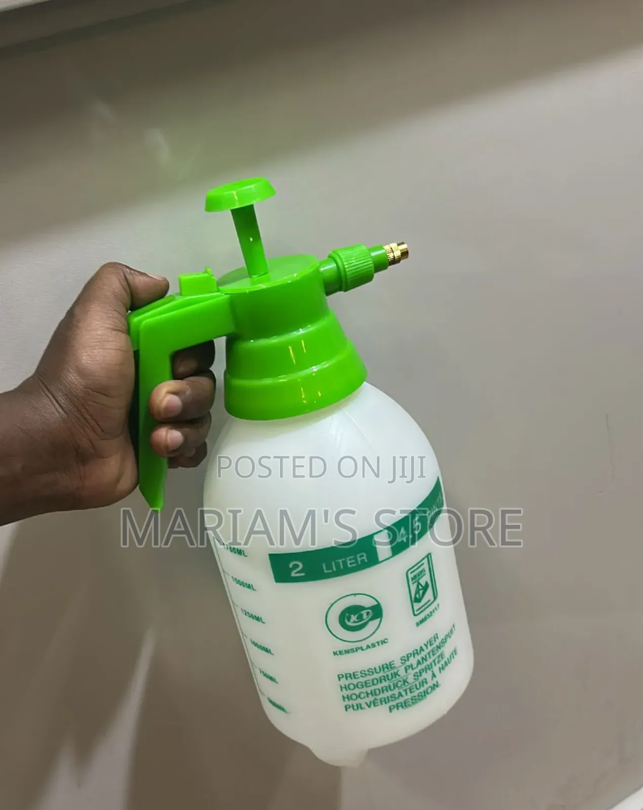 2-Liter Pressure Sprayer With a Green Pump Handle and a White Bottle.