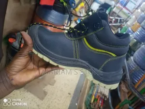 Black Industrial Safety Boots With Yellow Accent Stitches.