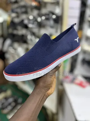 These Are Blue Slip-on Knit Sneakers Featuring a White Rubber