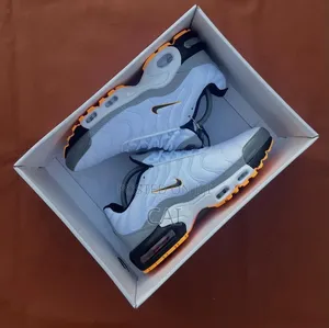 Nike Air Max Plus Tn Sneakers in a White and Gold Colorway.