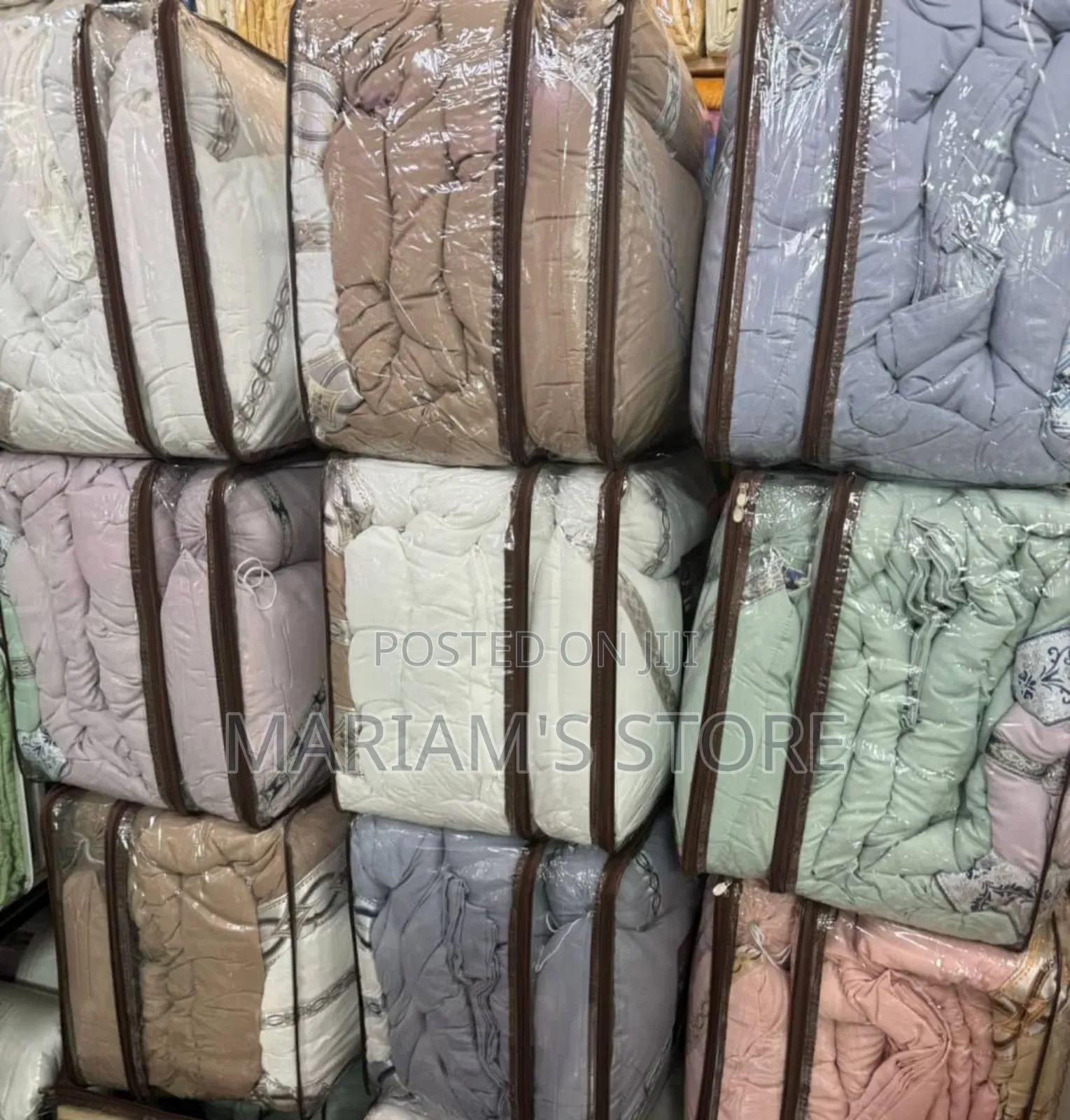 Beige and White Comforters Are Packed in Clear, Zippered Storage Bags