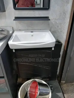 Sleek Black Vanity Set Ft a White Ceramic Basin Sink and a Marbl