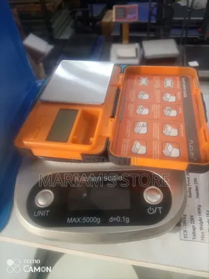 Pocket Scale With A Bright Orange Protective Case.
