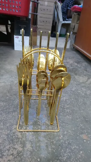 Gold-Plated Cutlery Set Features 24 Pieces in a Matching Wire Stand.