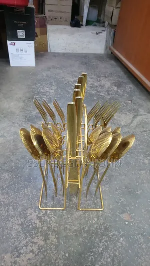 Gold-Plated Cutlery Set Features 24 Pieces in a Matching Wire Stand.