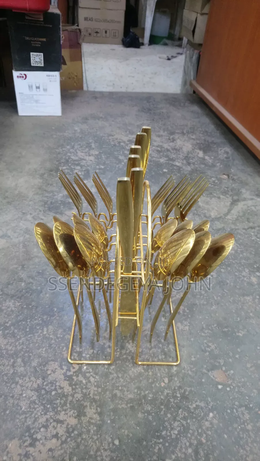 Gold-Plated Cutlery Set Features 24 Pieces in a Matching Wire Stand.