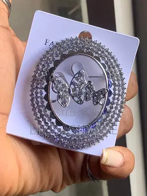 Butterfly Brooch With a Circular Frame Adorned With Rhinestones