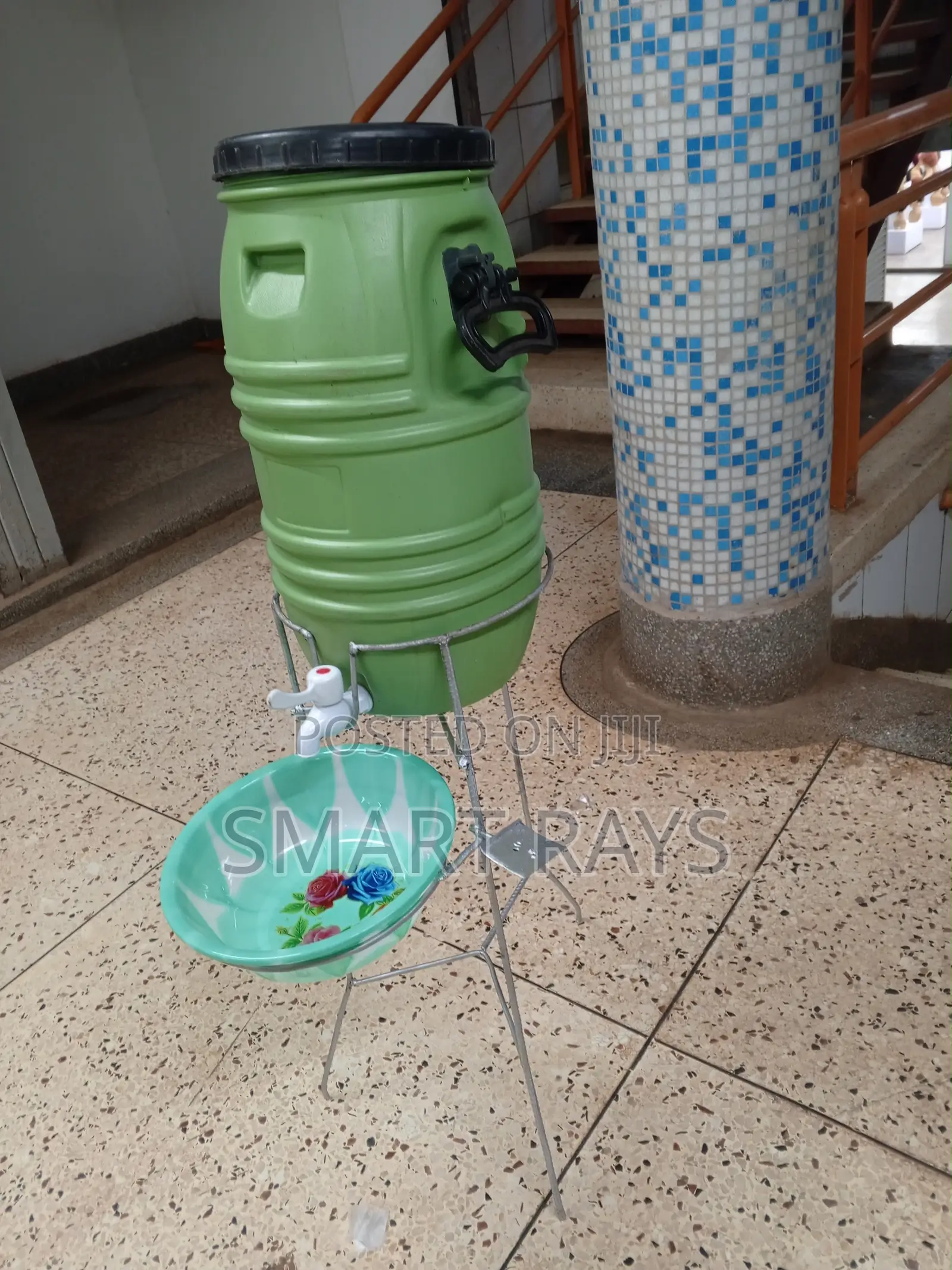 Plastic Water Tank With A Tap And A Metal Stand
