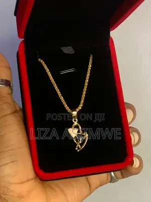 Lady’S Gold-Tone Heart Necklace Features a Distinctive Pendant
