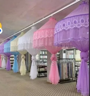 Hanging Mosquito Nets Featuring Decorative Lace Trimming.