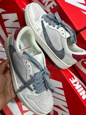 Nike Air Jordan 1 Low, Travis Scott, and Louis Vuitton Branding.
