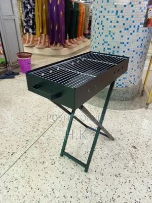 Portable Charcoal Barbecue Grill Featuring a Foldable X-Shaped Stand.