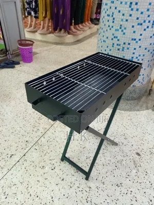 Portable Charcoal Barbecue Grill Featuring a Foldable X-Shaped Stand.