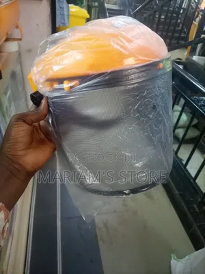 Safety Helmet With A Clear Plastic Brim And A Metal Mesh Visor.