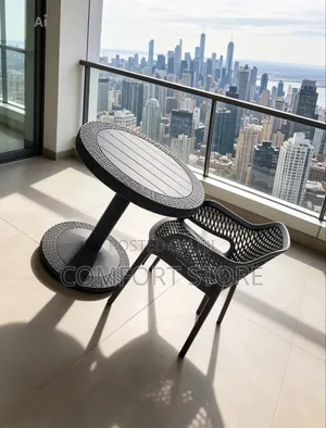 Plastic Dinning Set With a Round Black Table and Chairs
