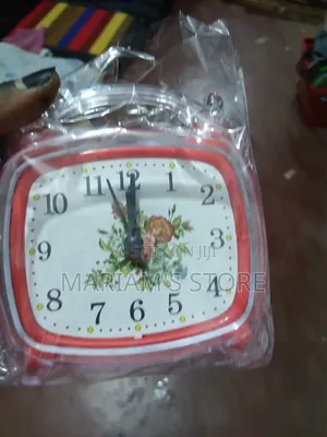 Red Alarm Clock Features a Vintage-Style Floral Design on Its Face.