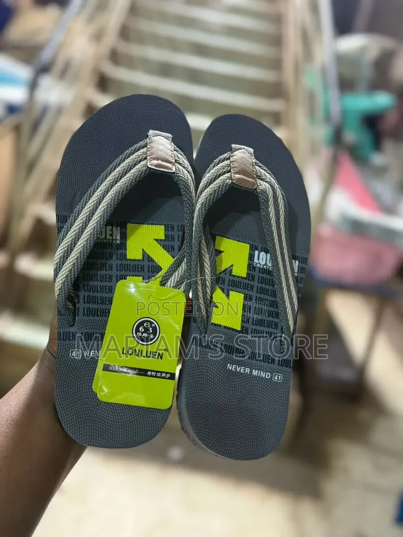 Flip Flops Feature a Navy Blue Base With Grey and Beige Woven Straps
