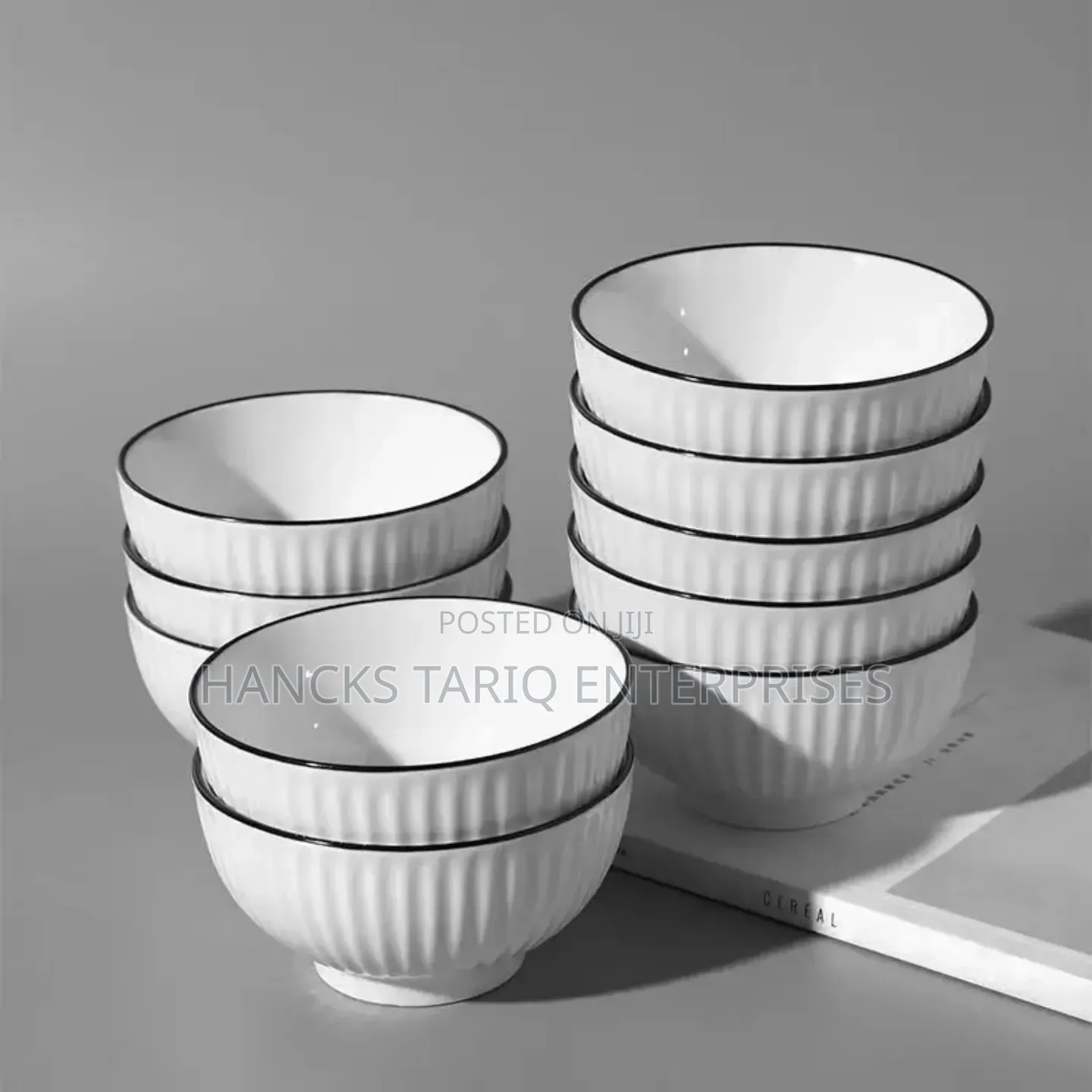 White Ceramic Bowls With Vertical Fluted Ridges and Dark Rims.