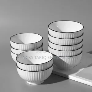 White Ceramic Bowls With Vertical Fluted Ridges and Dark Rims.