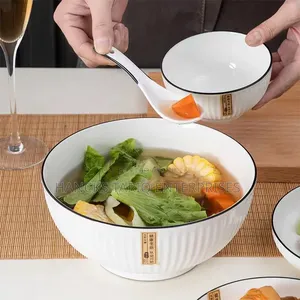 White Ceramic Bowls With Vertical Fluted Ridges and Dark Rims.