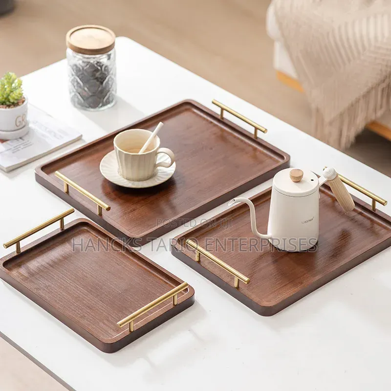 Set of Nested Wooden Serving Trays With Gold Handles.