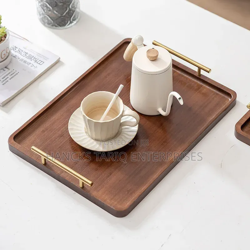 Set of Nested Wooden Serving Trays With Gold Handles.