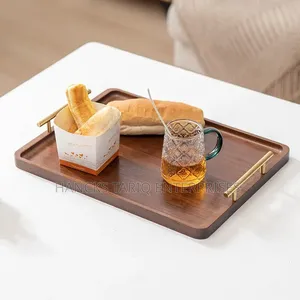Set of Nested Wooden Serving Trays With Gold Handles.
