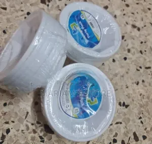 Set of White, Disposable Plastic Plates Packaged for Party Use.