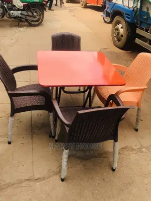 A Set of Table and 4 Plastic Chairs.